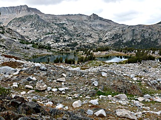 Green Treble Lake with edge of Mt. Conness in background.