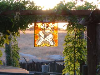 Stained-glass image of Hopi girl hanging from Wisteria trellis