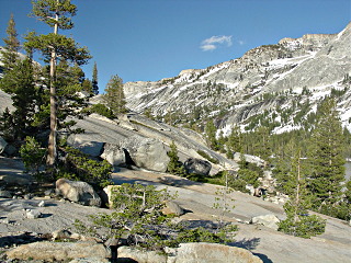 Picture of the canyon walls above Tanaya Lake with a part of the lake shown in the lower right.